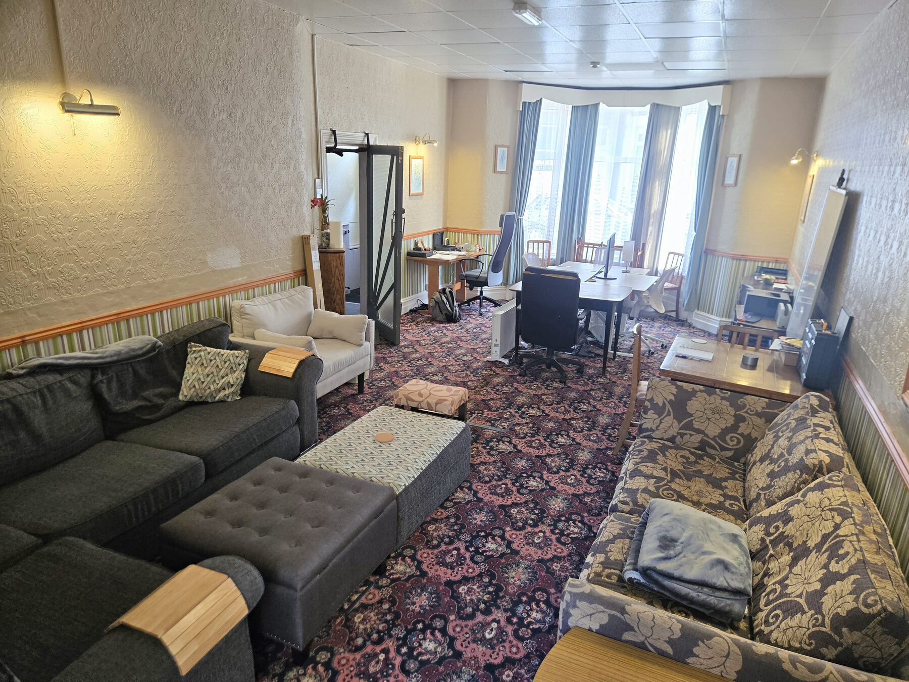 The lounge at Moratorium House, with sofas around a bay window